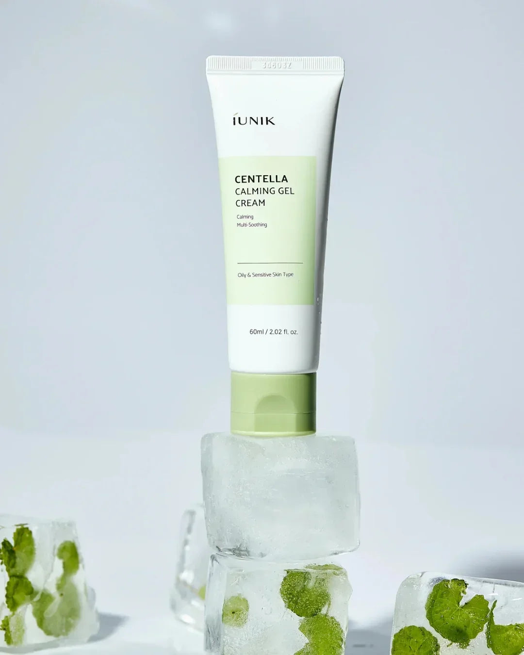 iUNIK Centella Calming Gel Cream tube balanced on ice cubes with green leaves inside