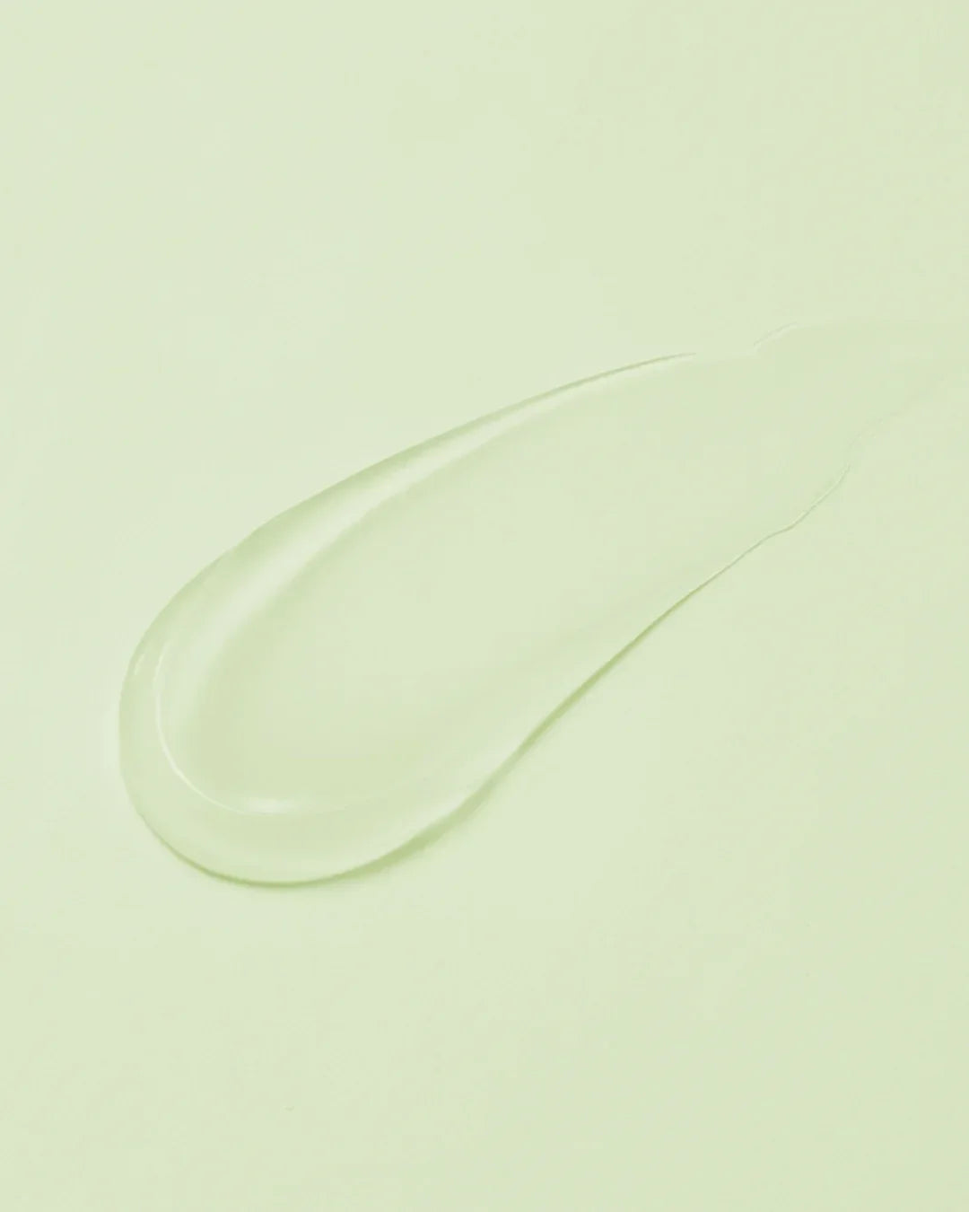 Smooth transparent centella calming gel cream texture on light green background