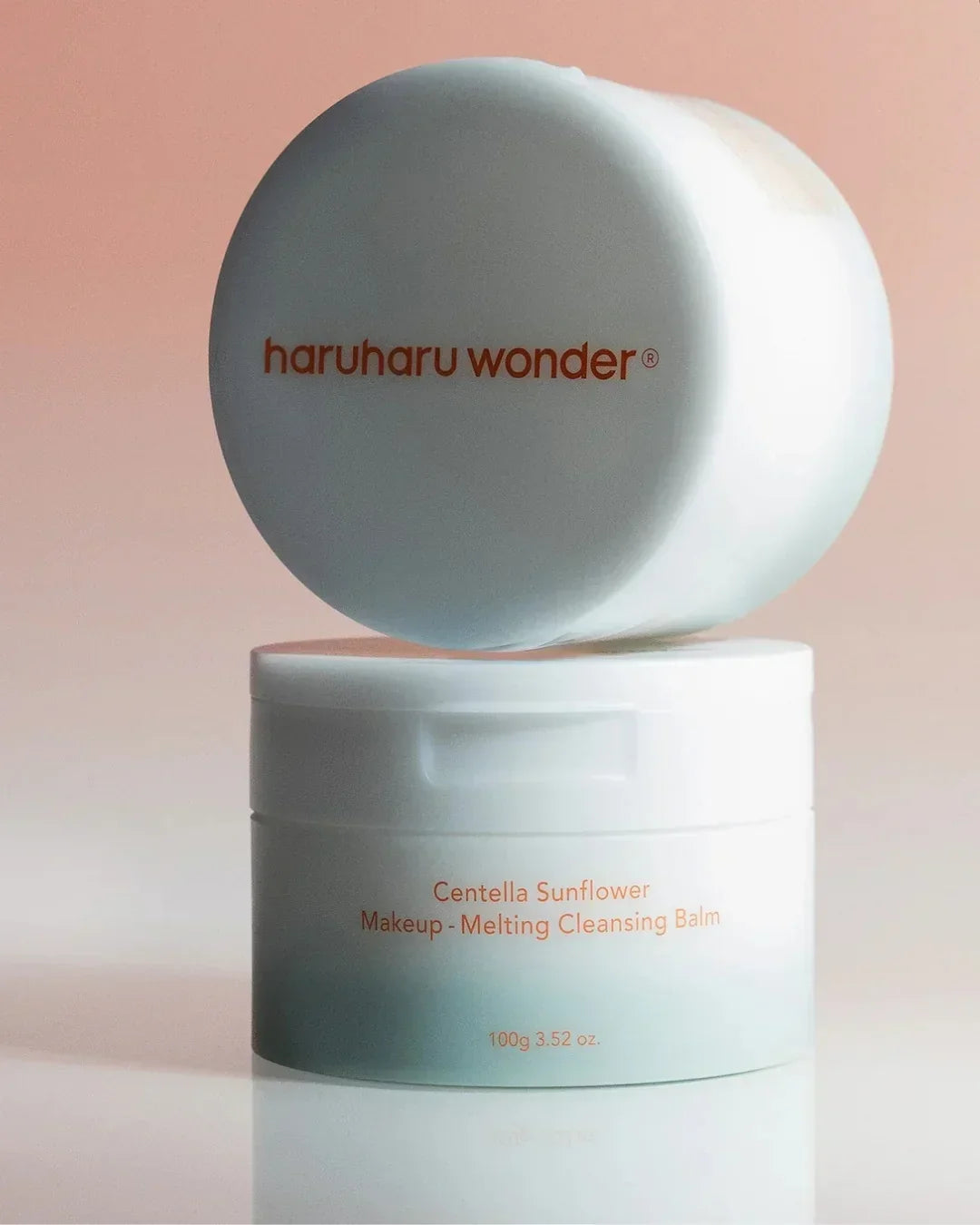 Haruharu Wonder Centella Sunflower Makeup Melting Cleansing Balm 100g container on pink background