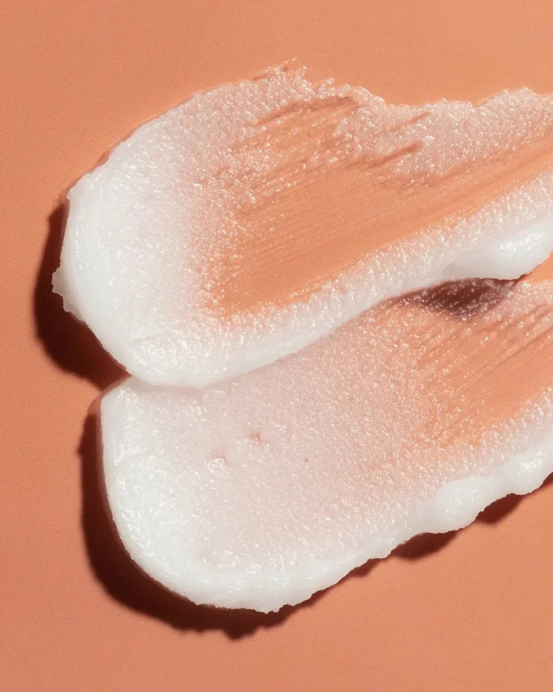 Close-up of white centella sunflower makeup melting cleansing balm texture on terracotta surface