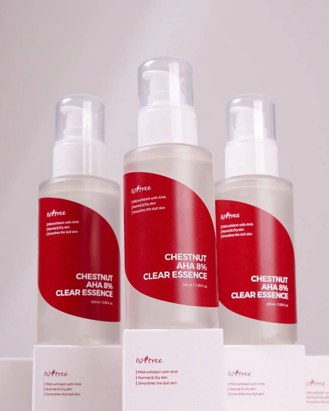 Three bottles of Isntree Chestnut AHA 8% Clear Essence skincare with red labels on white boxes
