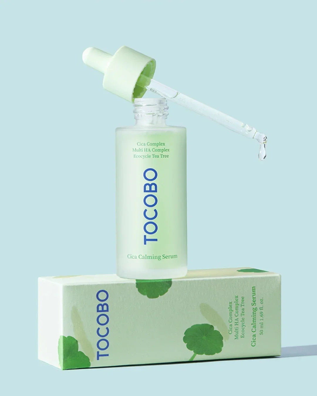 TOCOBO Cica Calming Serum bottle with dropper and product box against light blue background