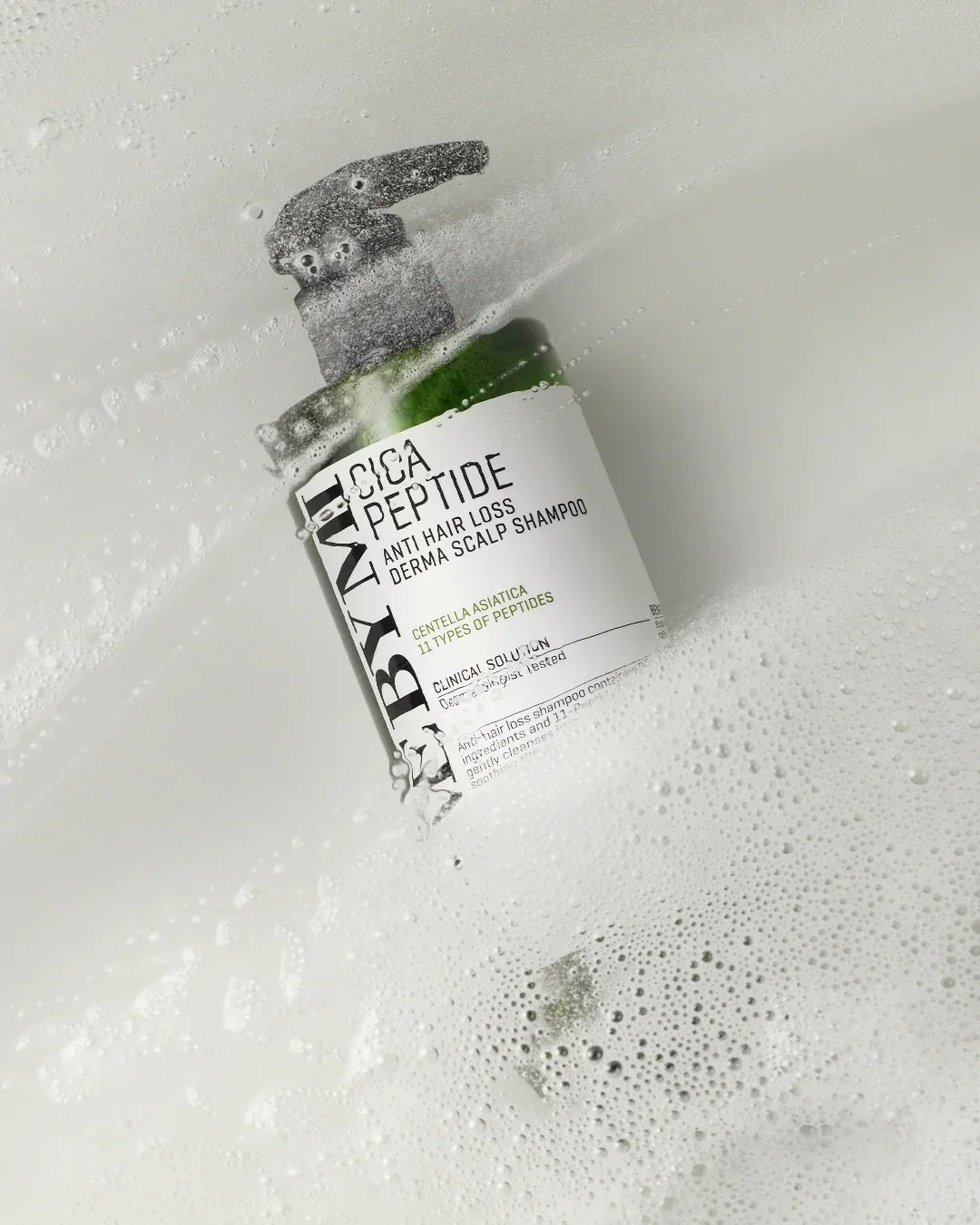 Bymine Cica Peptide anti hair loss derma scalp shampoo bottle in foamy water in white tub