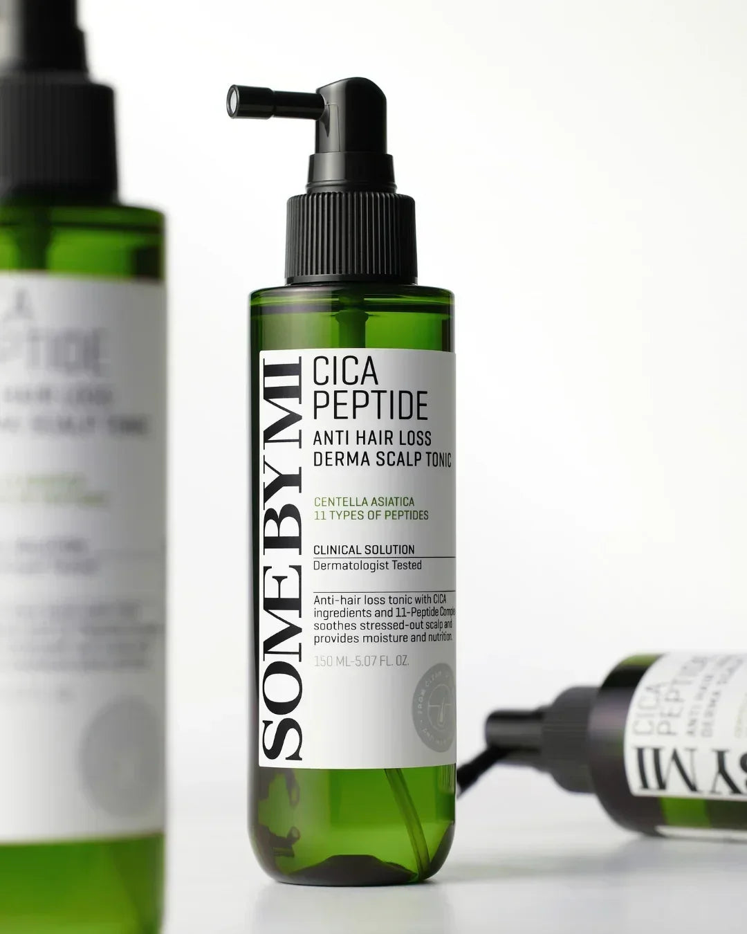 Green bottle of SOME BY MI Cica Peptide Anti Hair Loss Derma Scalp Tonic with pump dispenser on white background