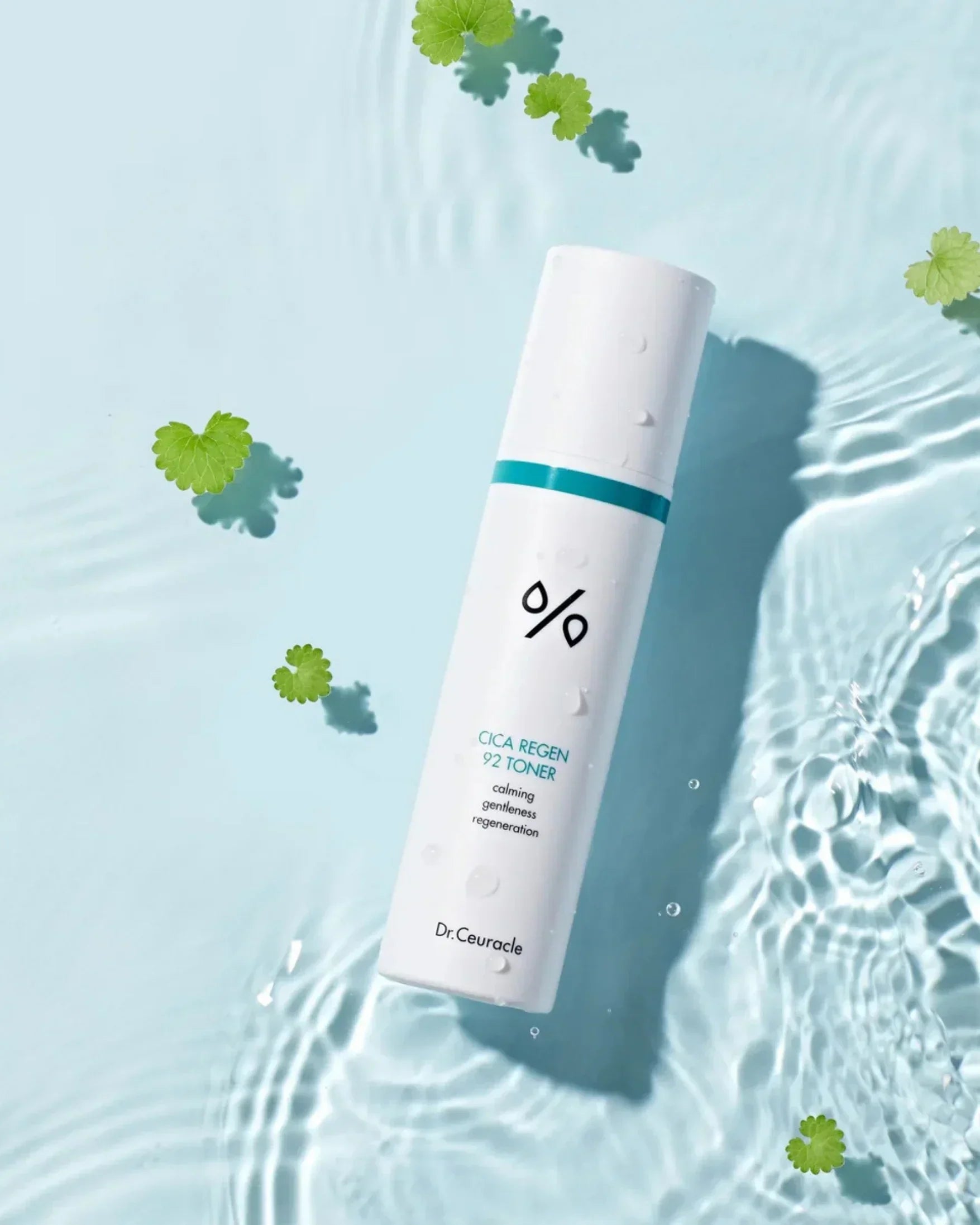 Dr.Ceuracle Cica Regen 92 Toner bottle with water droplets surrounded by floating green leaves on light blue water surface