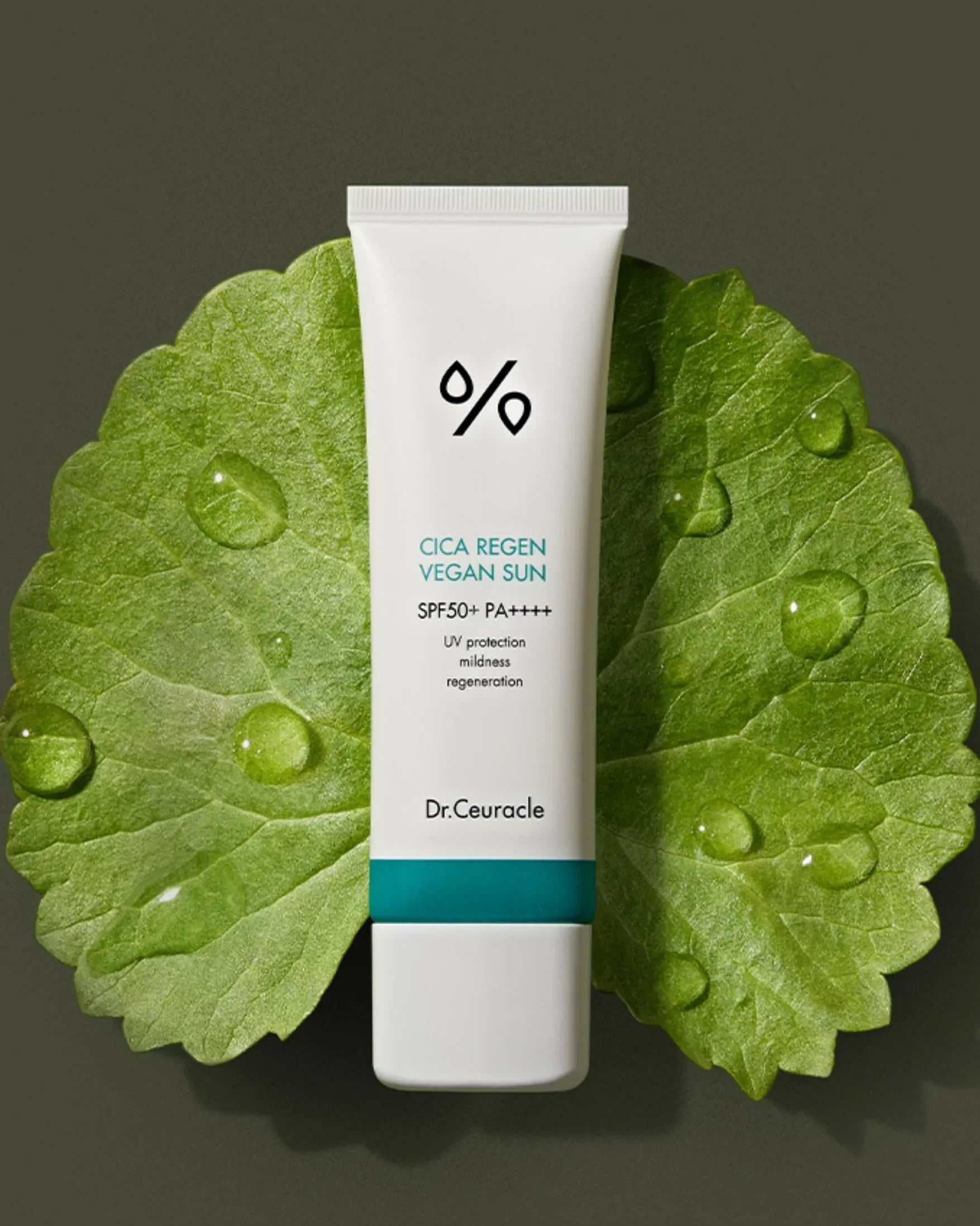 Dr. Ceuracle Cica Regen Vegan Sun SPF50+ PA++++ sunscreen tube on green leaf with water drops