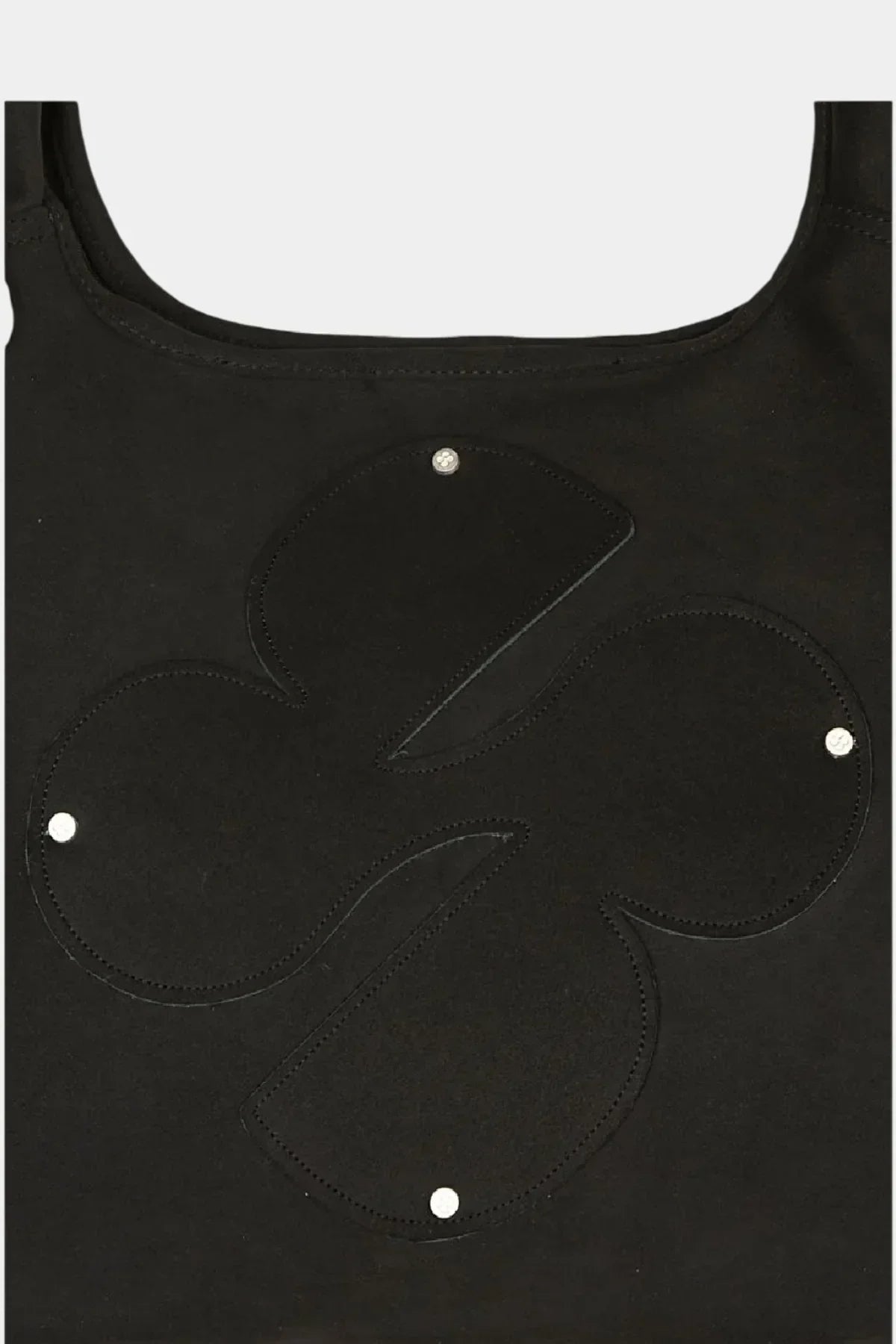 Close-up of black artificial suede shoulder bag with large clover emblem and silver rivets