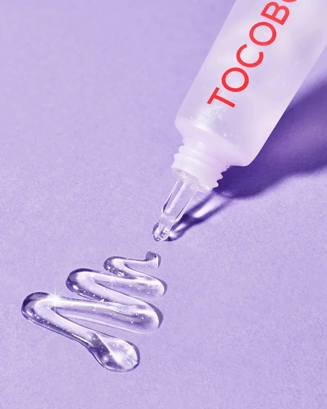 Tube of Tocobo collagen brightening eye gel cream dispensed on purple surface