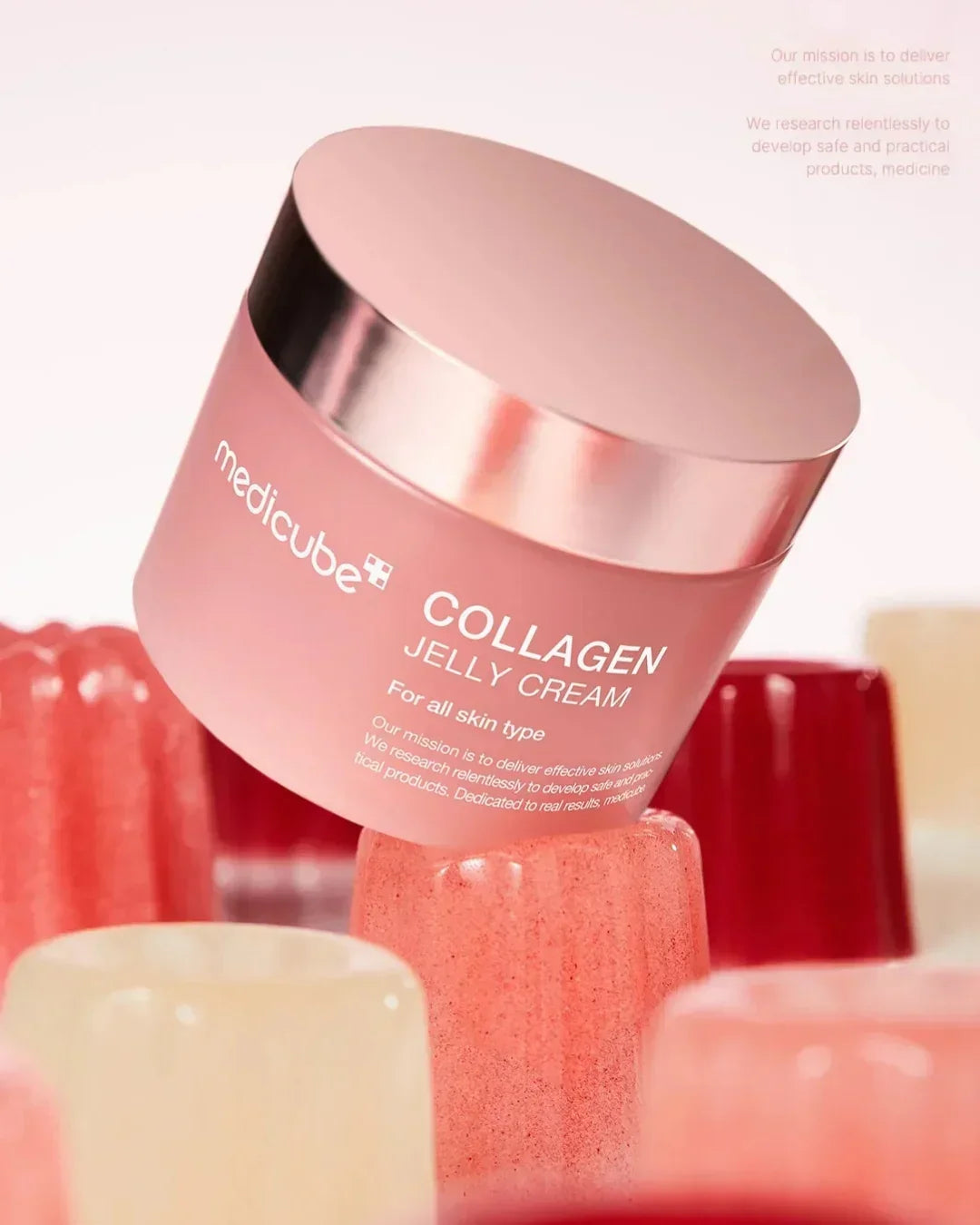 Medicube Collagen Jelly Cream for all skin types in a pink jar with rose gold lid, surrounded by colorful jelly shapes