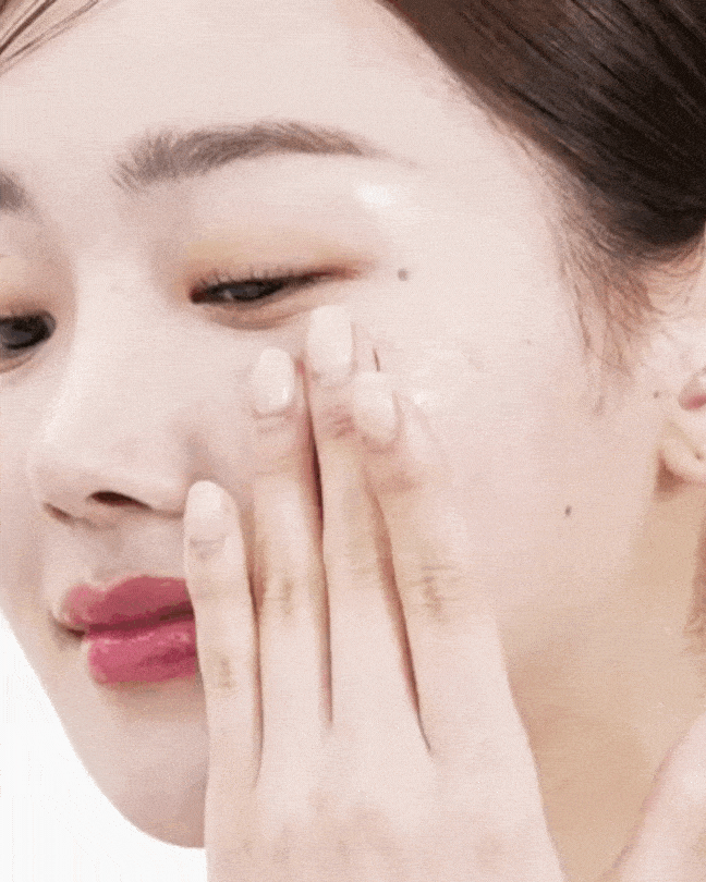 Woman gently applying collagen jelly cream to cheek for hydrating skincare routine