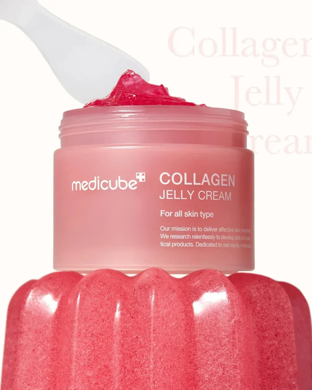 Medicube Collagen Jelly Cream jar with pink translucent jelly cream on white spatula, skincare product