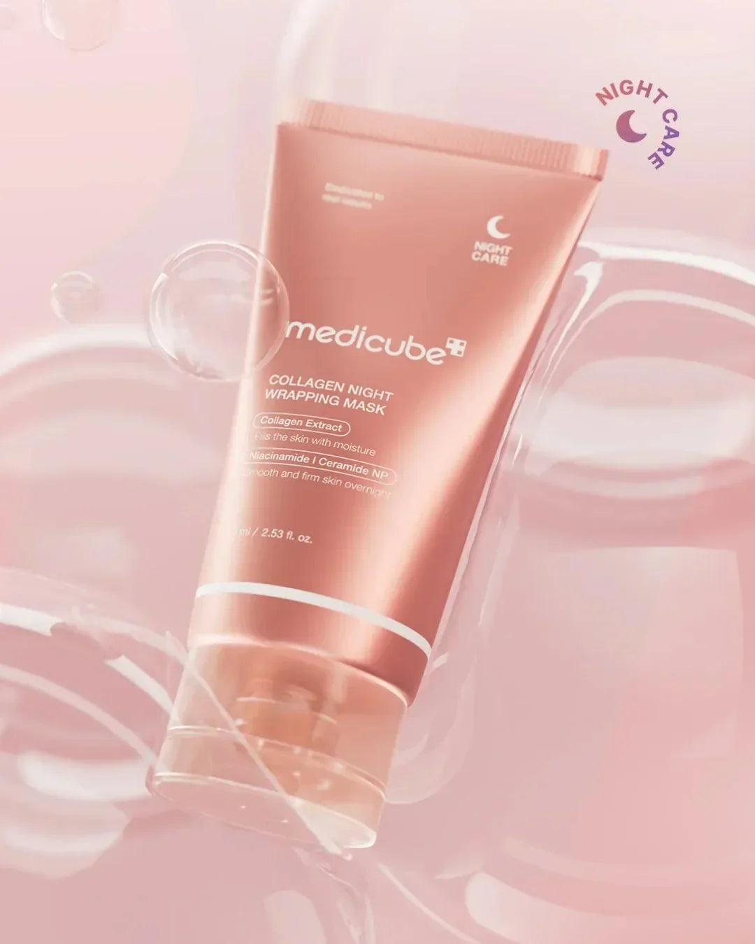 Medicube Collagen Night Wrapping Mask tube on pink background with floating bubbles, skincare product