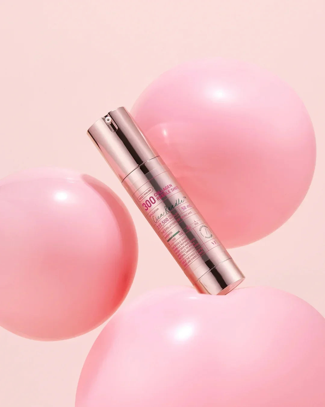 Collagen serum bottle with pink label surrounded by pink balloons on a soft pink background