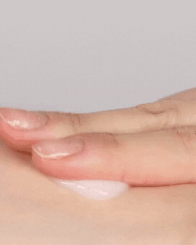 Person applying white collagen cream on smooth skin for skincare and anti-aging