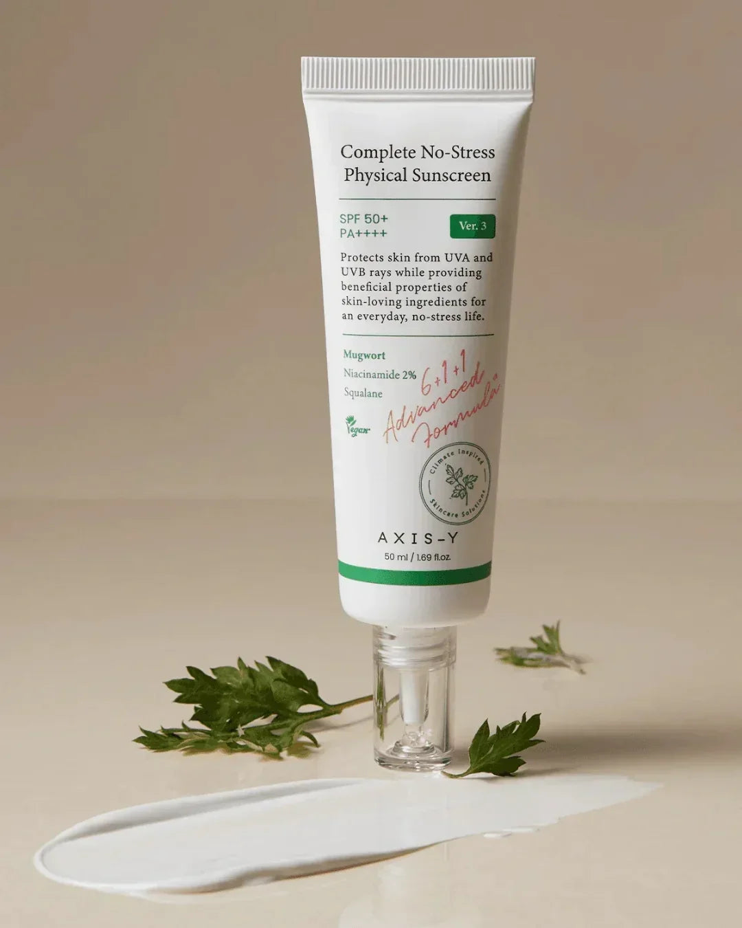 Complete No-Stress Physical Sunscreen SPF 50+ tube with skin cream spread and green leaves