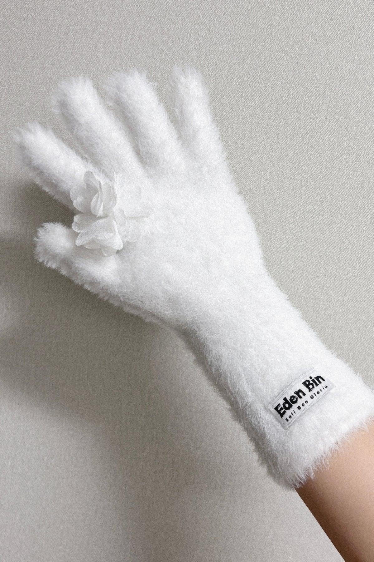 White fluffy glove with couture flower applique and Eden Bin label on wrist against gray background