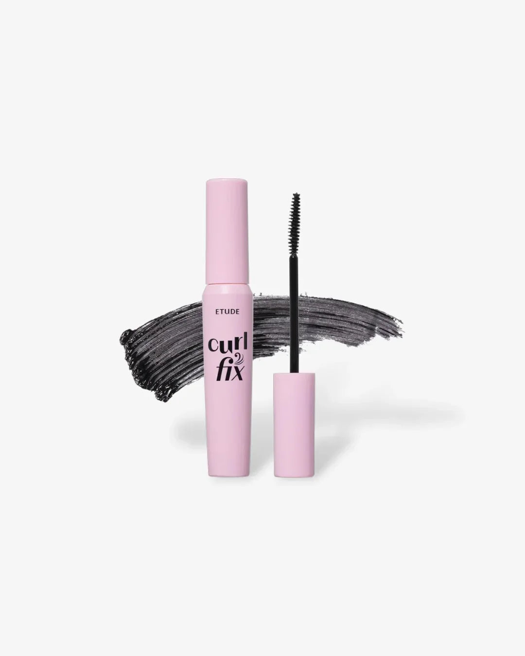 Pink tube of Etude Curl Fix mascara with black brush and black mascara smear background