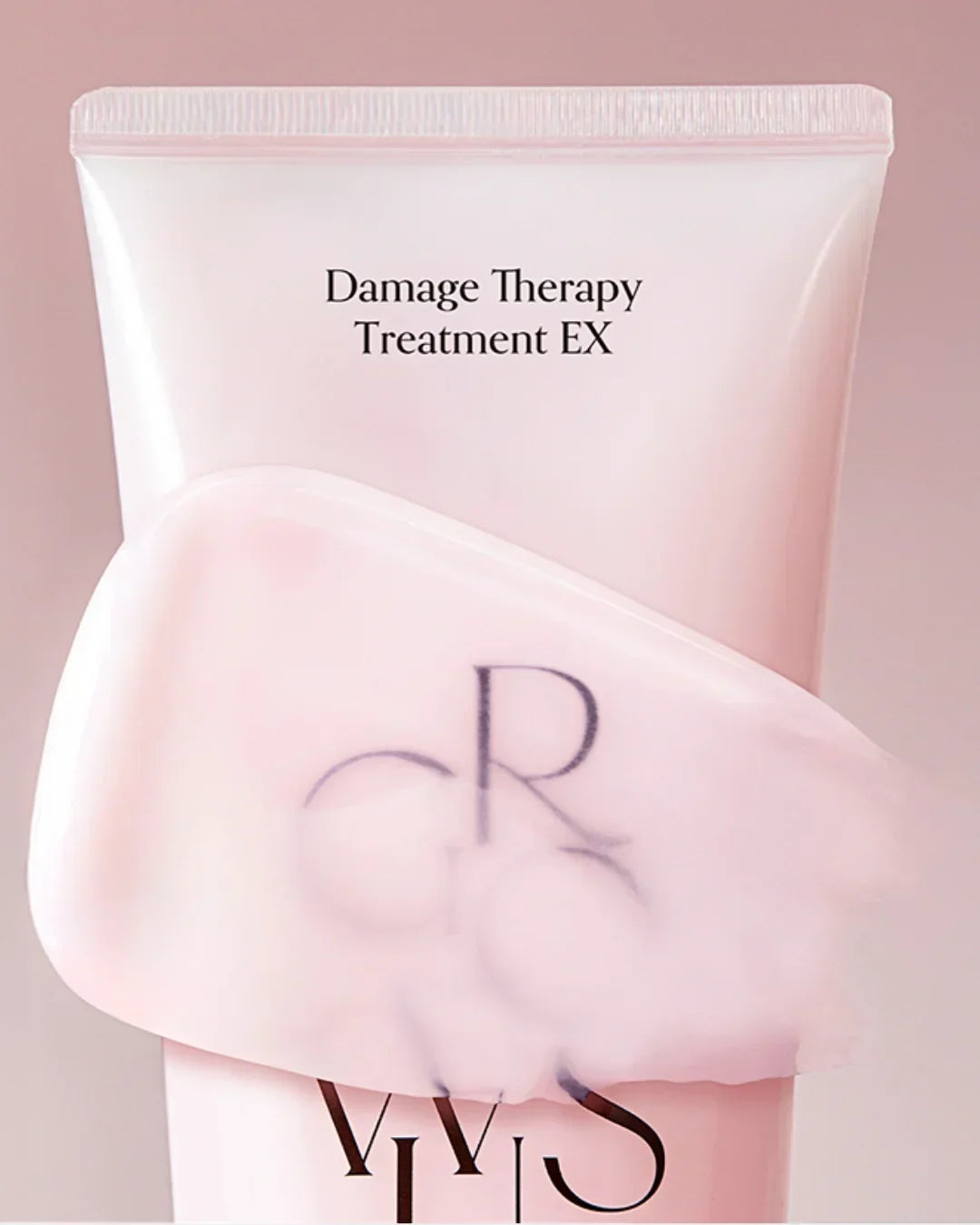 Pink tube of Damage Therapy Treatment EX hair care with creamy texture on soft pink background