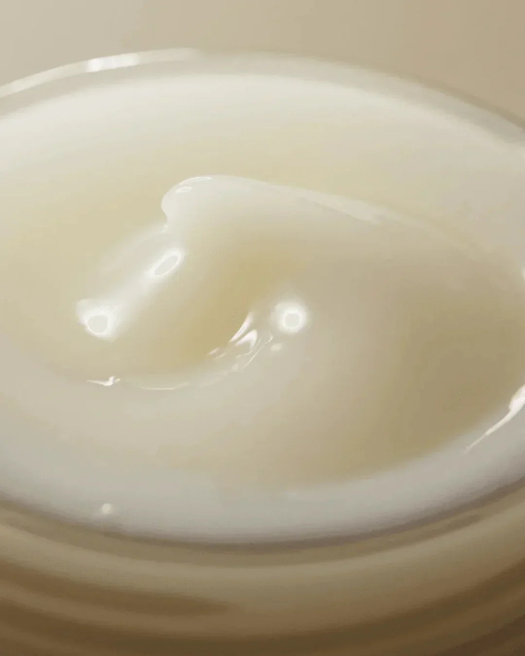 Close-up of creamy white skincare cream texture in container for dark spot correction