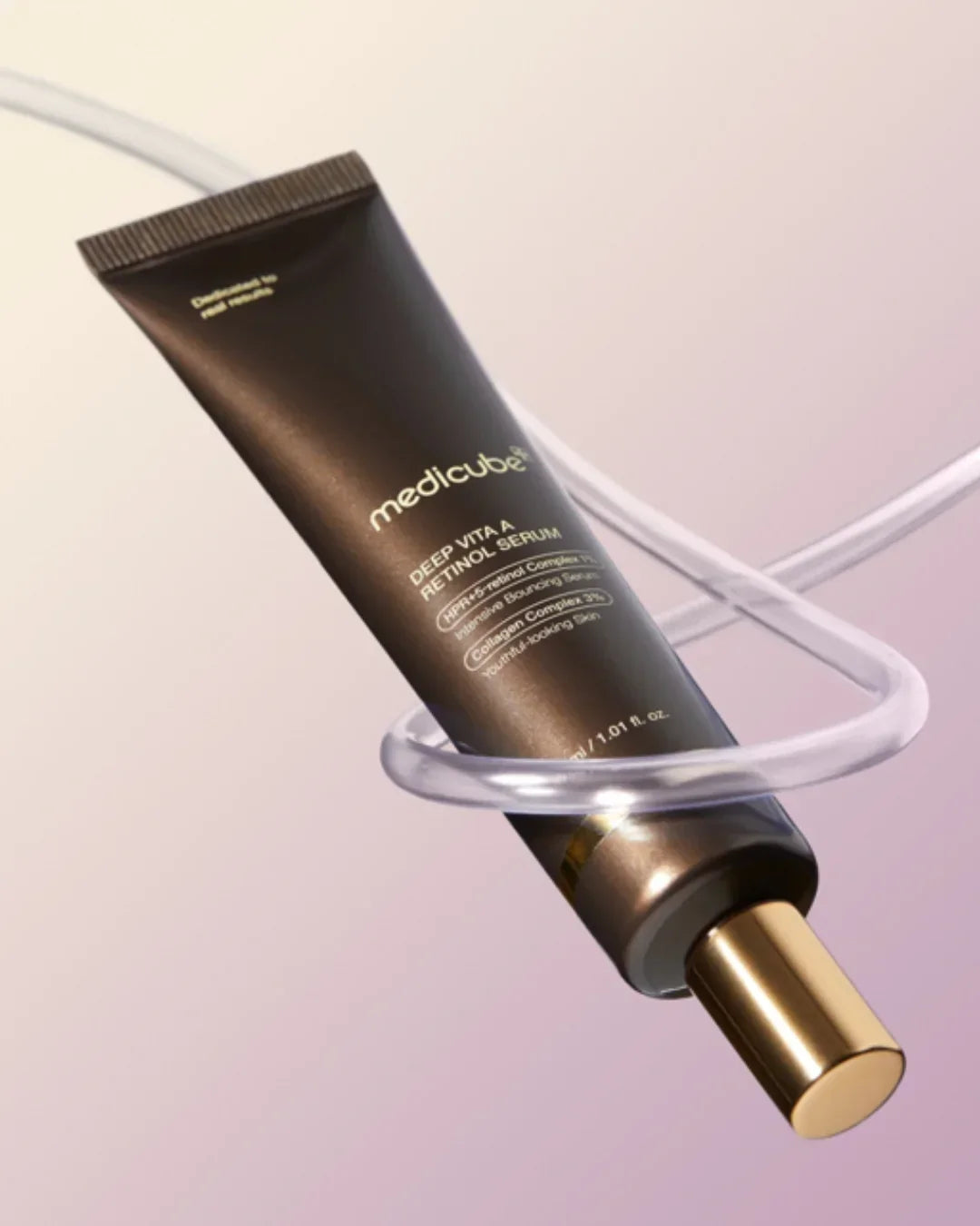 Medicube Deep Vita A Retinol Serum tube with gold cap floating with clear spiral on gradient background