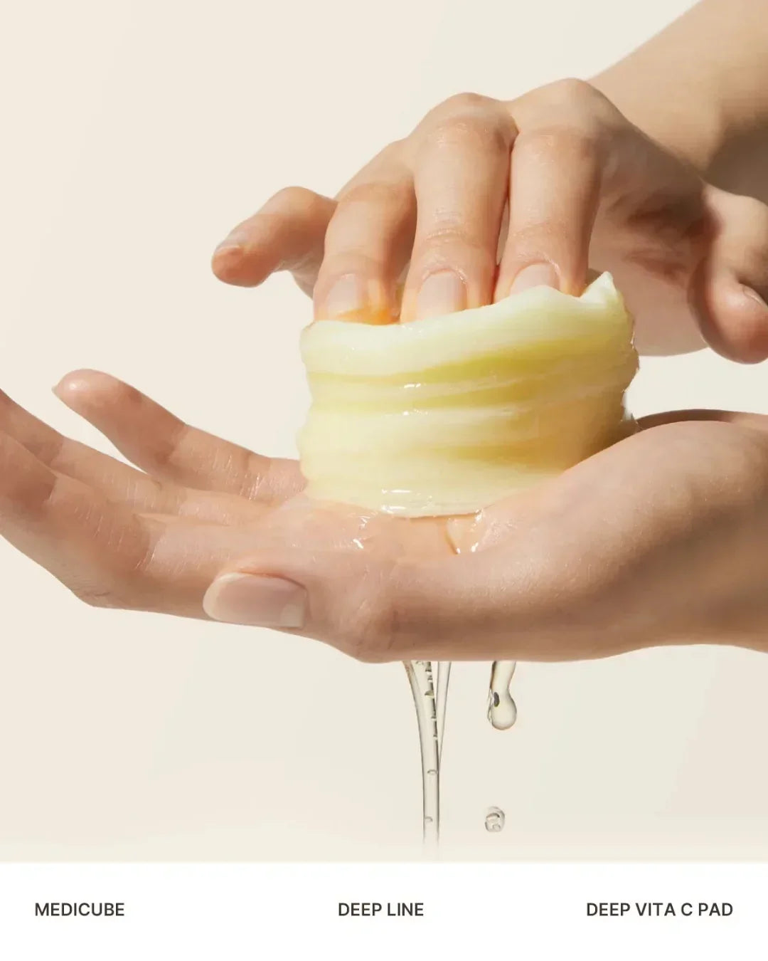 Hands squeezing yellow translucent Deep Vita C pads with serum dripping, skincare product close-up