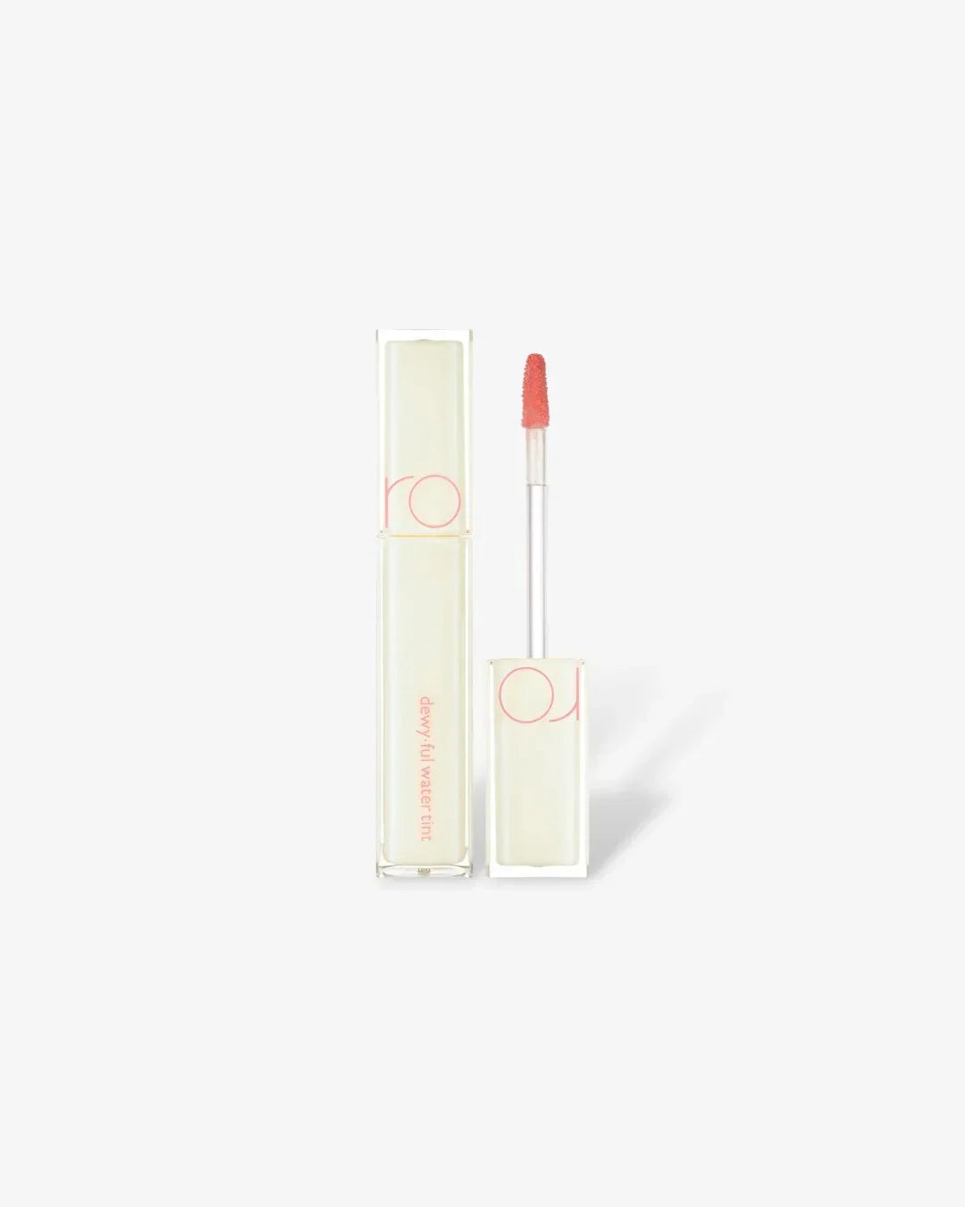 Dewyful Water Tint lip gloss with clear packaging and coral applicator on white background