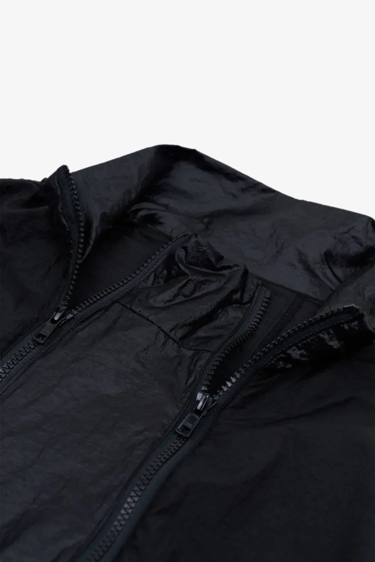 Close-up of black windbreaker jacket with double zippers and textured fabric
