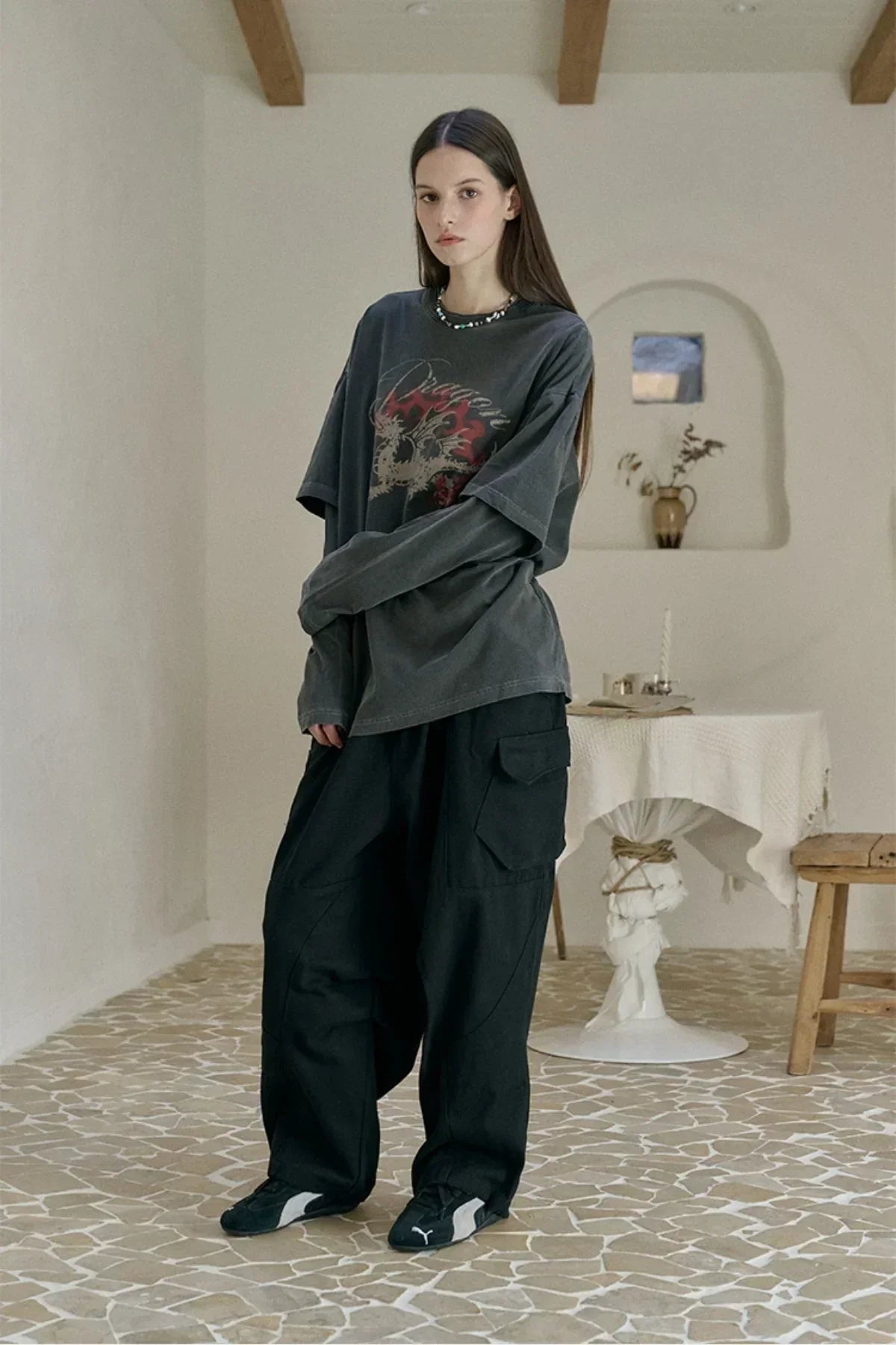 Model wearing smoke black dragon layered pigment long sleeve shirt and loose black cargo pants