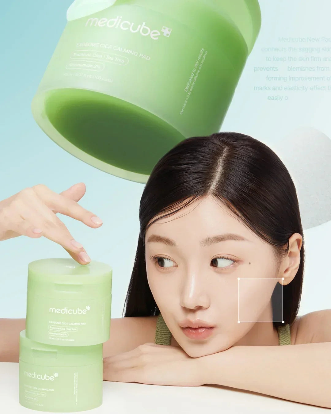 Medicube Exosome Cica Calming Pad skincare product jars with woman touching lid, clear skin, light blue background