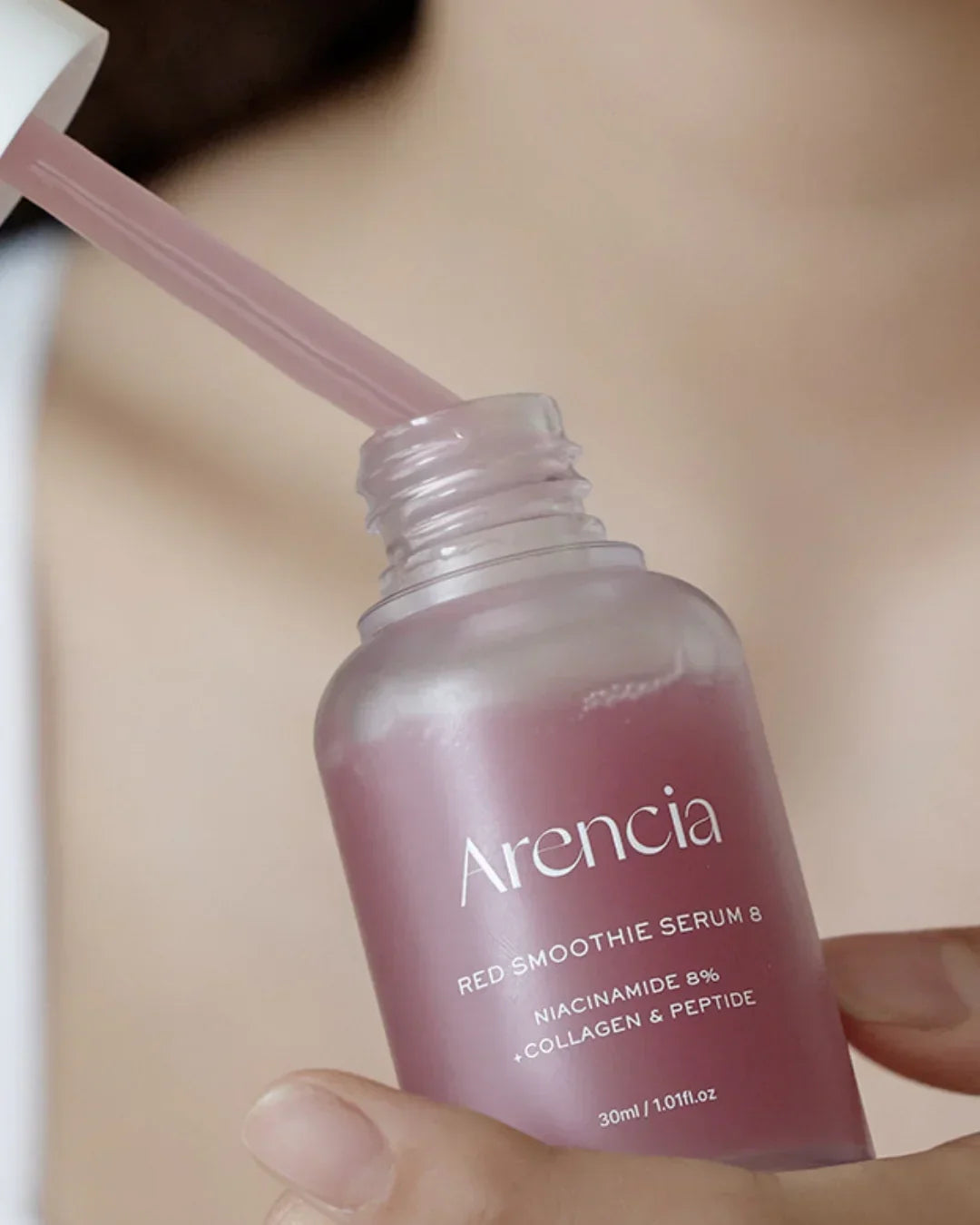 Close-up of Arencia Red Smoothie Serum 8 bottle with dropper, featuring niacinamide and collagen