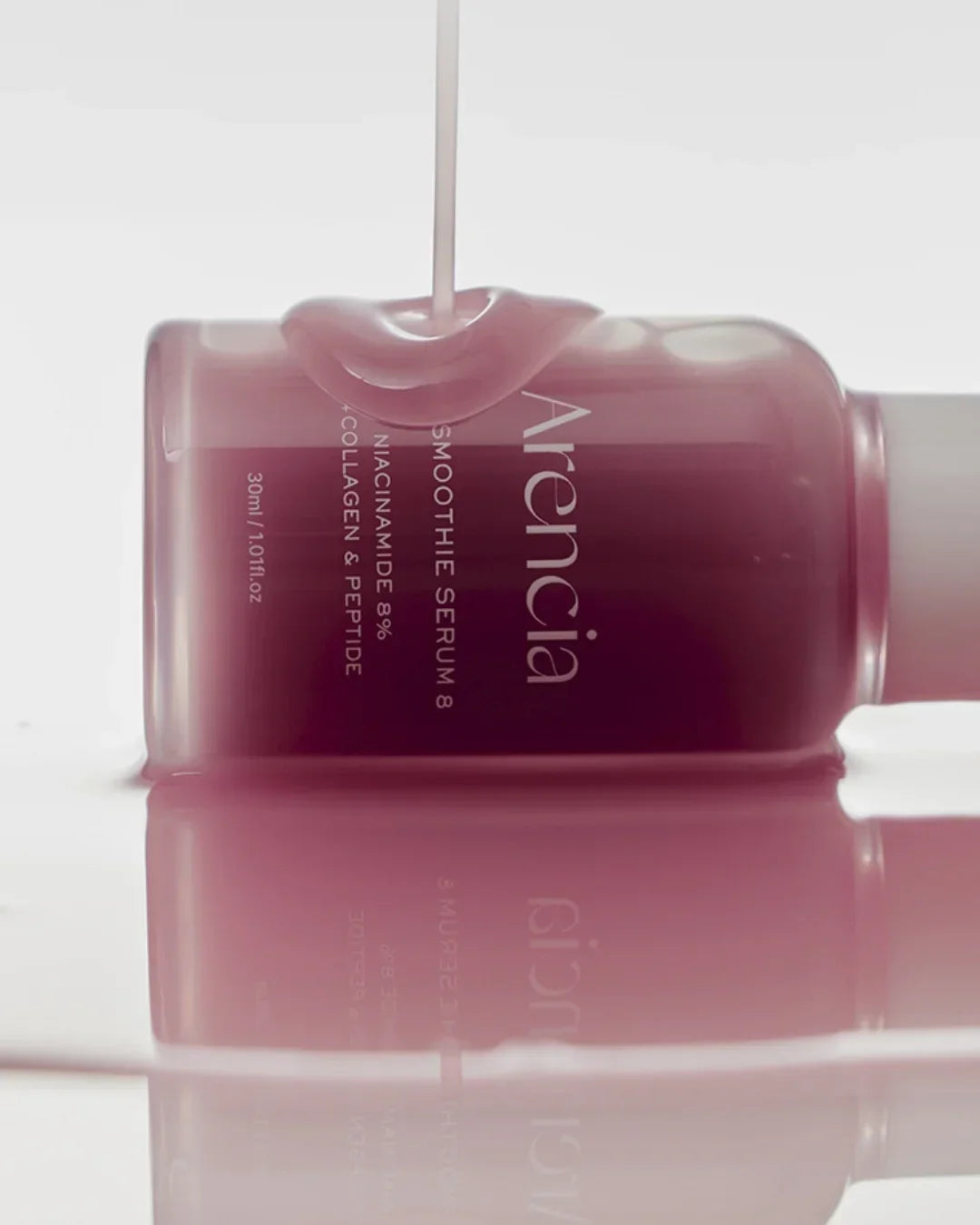 Arencia pink smoothie serum bottle with 8% niacinamide, collagen, and peptide, liquid texture