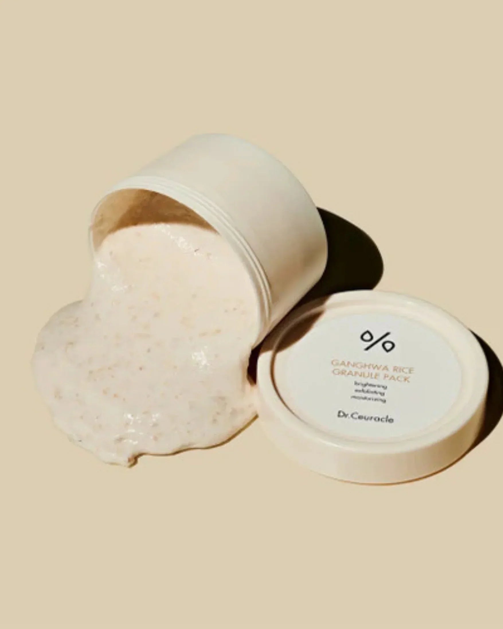 Open jar of Dr.Ceuracle Ganghwa Rice Granule Pack with creamy rice exfoliating mask spilling out