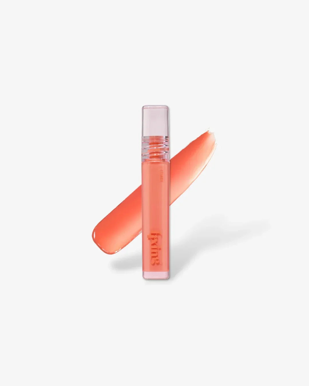 Peach-colored fixing tint lip gloss tube with swatch on white background