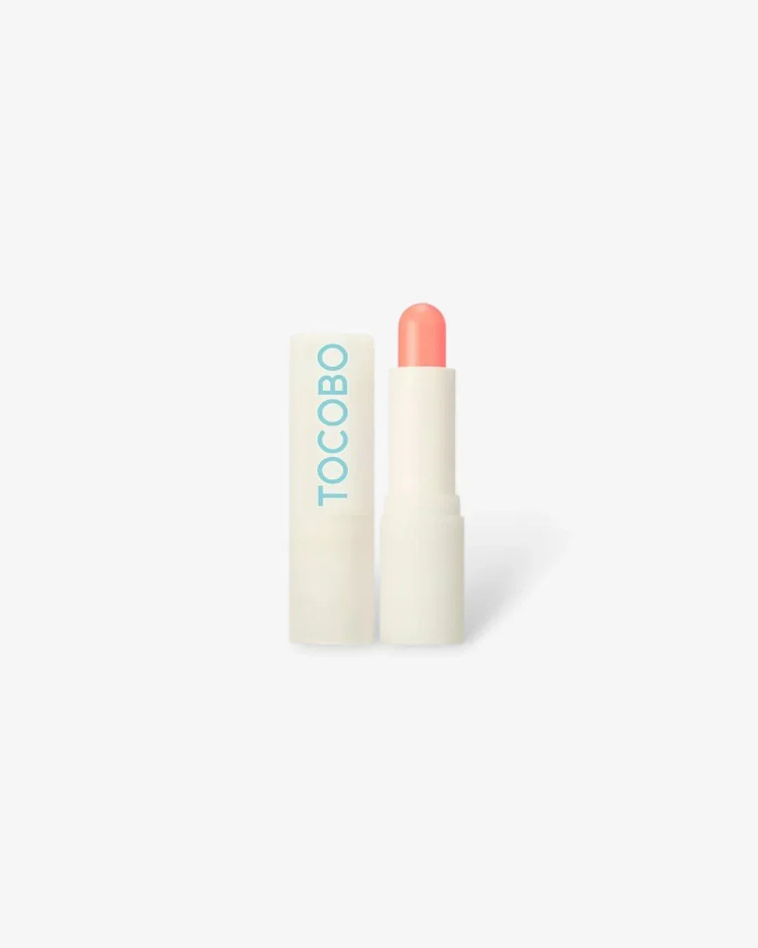 Tocobo Glow Ritual Renewal lip balm with coral-colored balm and white tube on white background