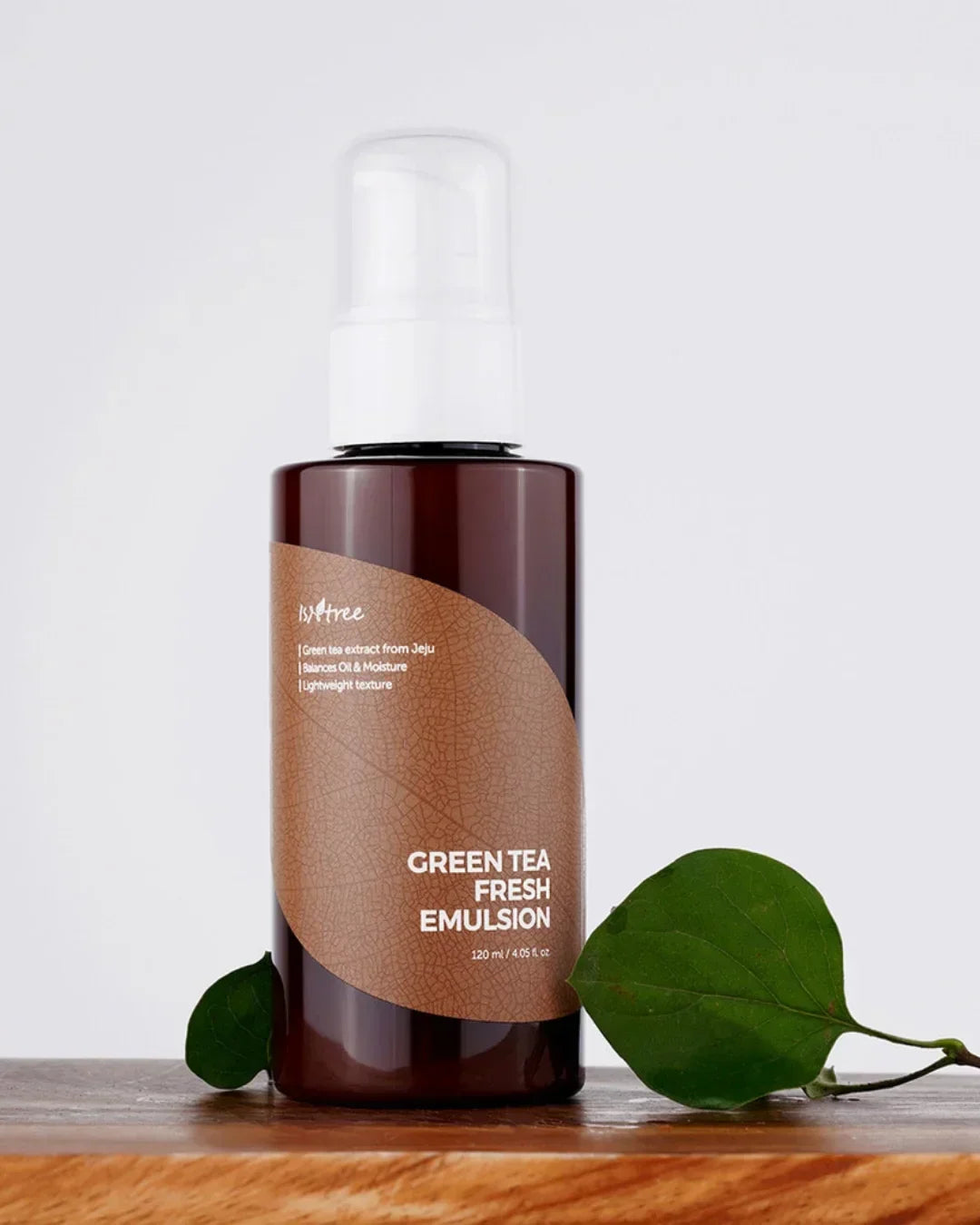Isntree Green Tea Fresh Emulsion 120ml bottle with pump on wooden surface and green leaves