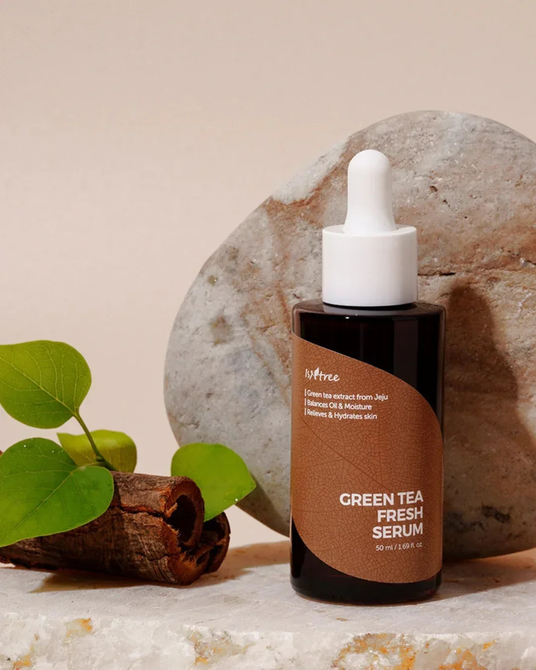 Isntree Green Tea Fresh Serum bottle with dropper on stone surface, green leaves and natural decor