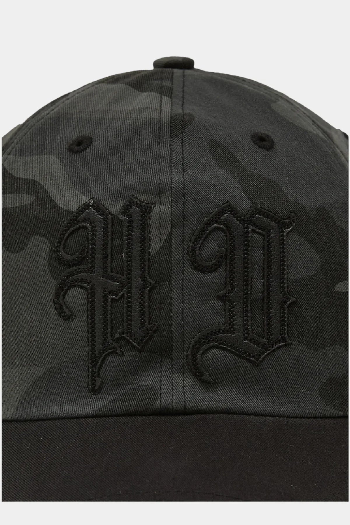 Close-up of grey camo ball cap with black gothic HP embroidered logo and black brim