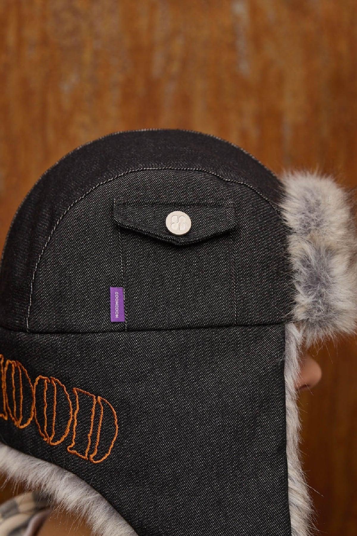Black denim fur trooper hat with orange embroidered text and a small pocket with button