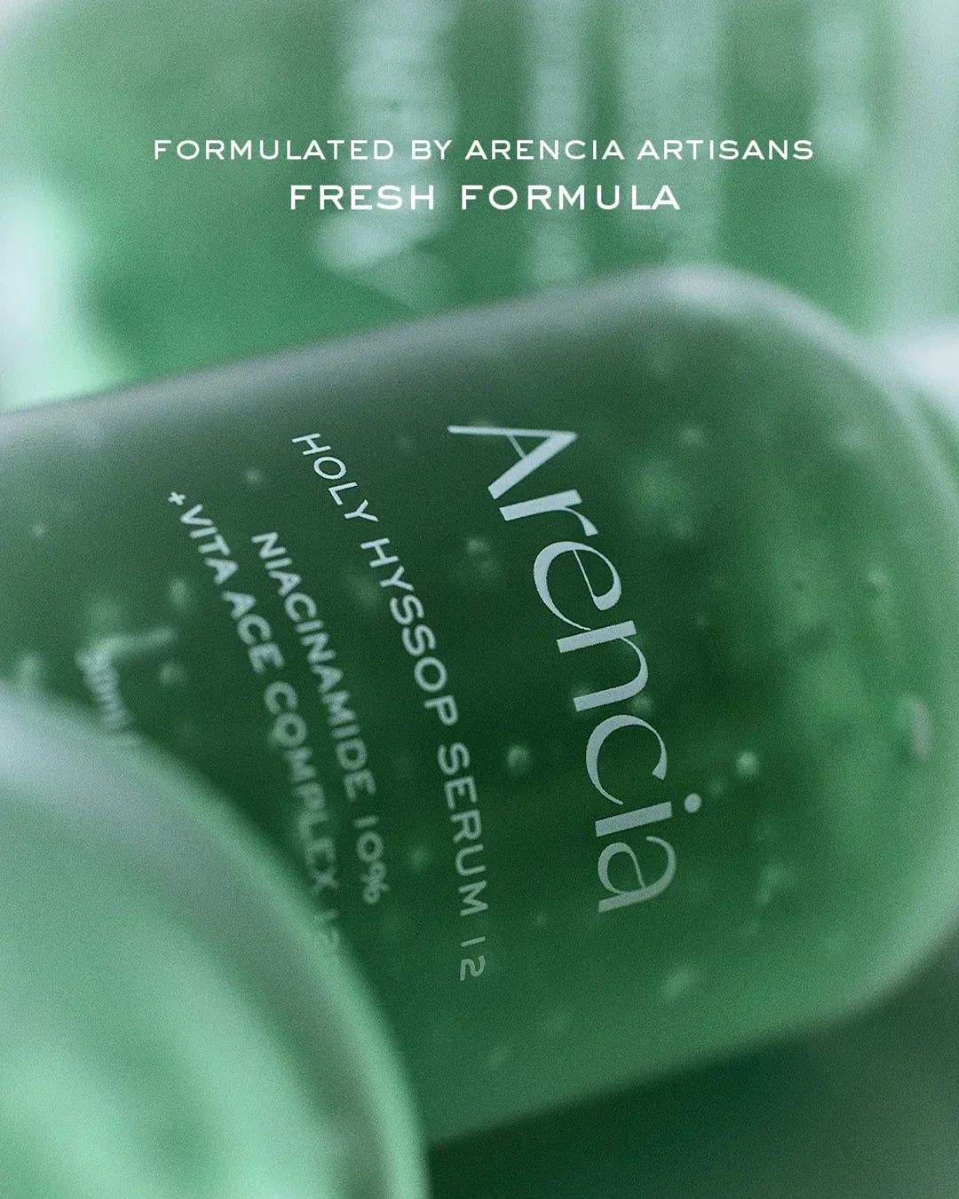Close-up of green Arencia Holy Hyssop Serum bottle with niacinamide and vitamin ace in a fresh formula