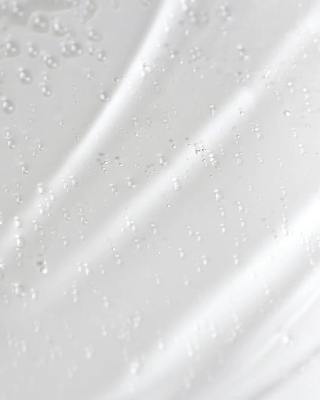 Close-up texture of PURITO SEOUL Hydro Wave Deep Sea Serum with tiny oxygen bubbles.