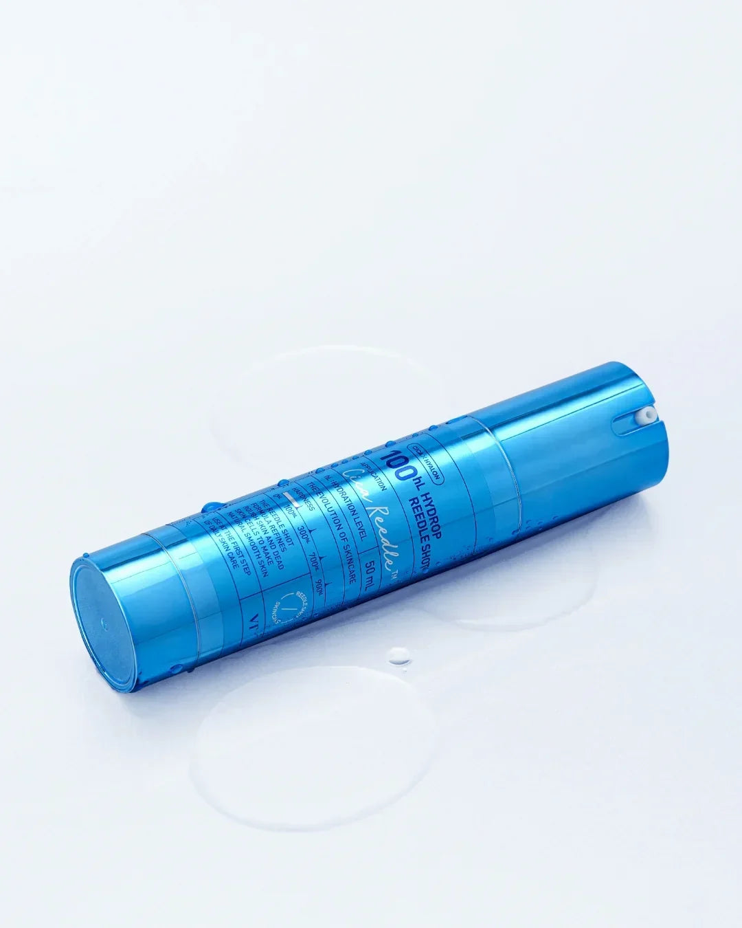 Blue cylindrical skincare bottle labeled 100 HL Hydrop Reedle Shot with water droplets on white surface
