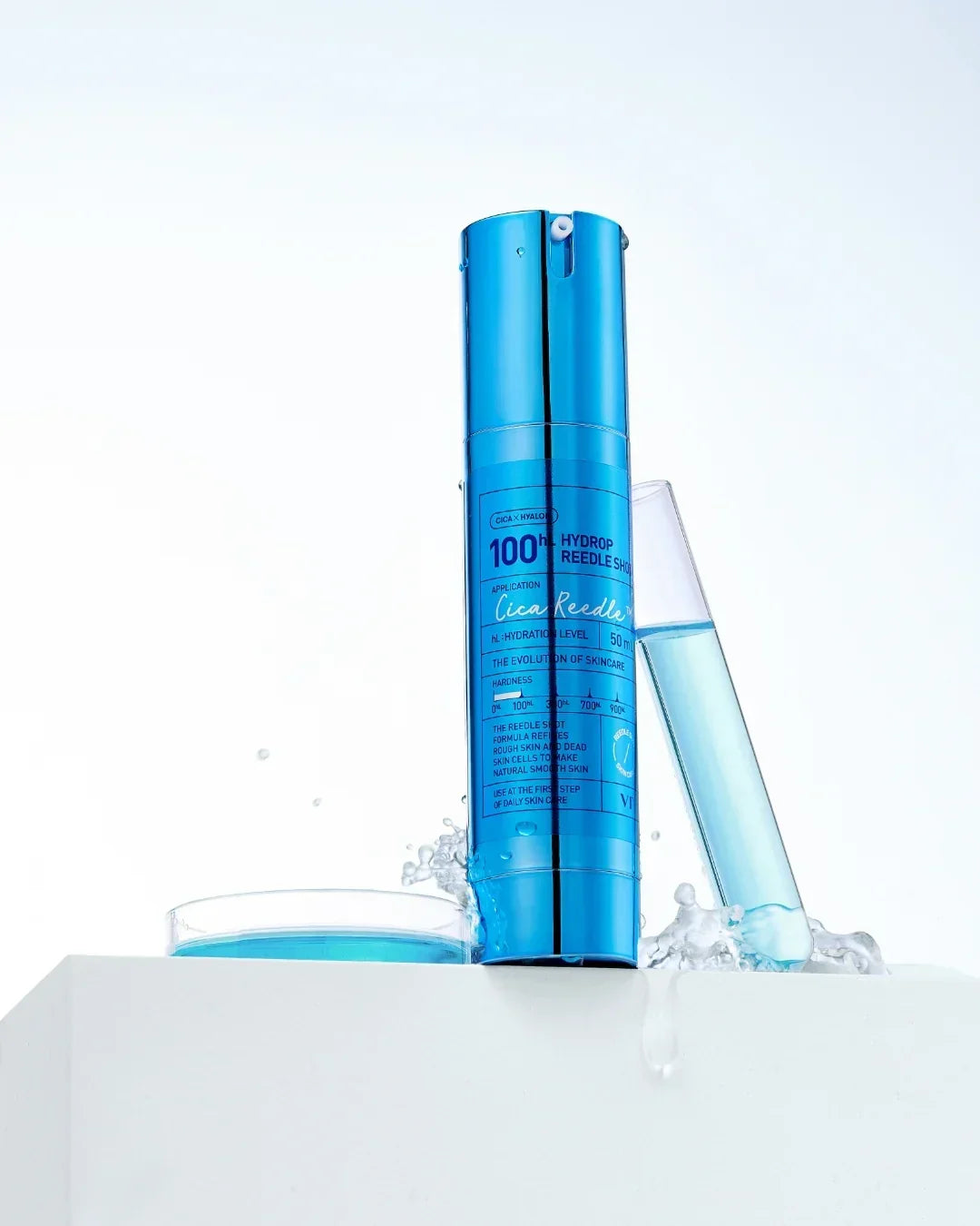 Blue Hydrop Reedle Shot skincare serum bottle with test tube and water splashes on white pedestal