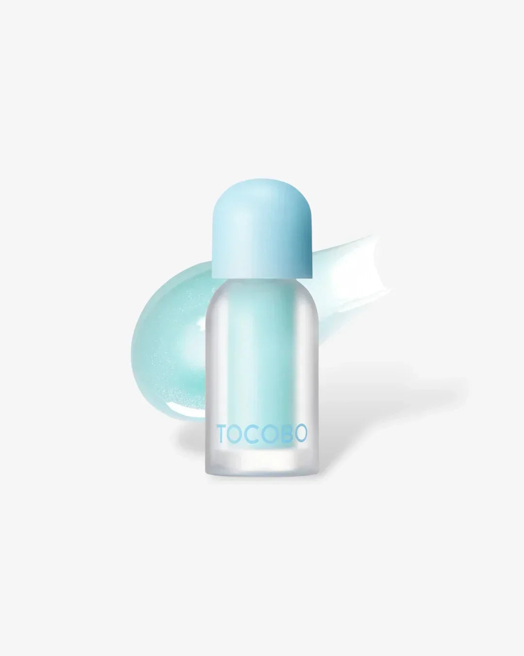 Small frosted glass bottle with blue cap labeled TOCOBO lip oil against white background