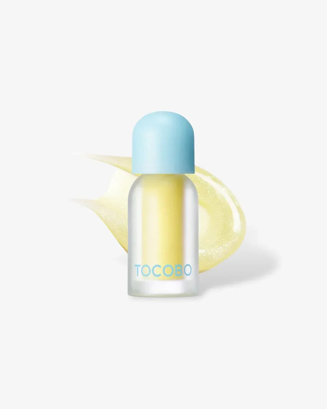 Tocobo yellow plumping lip oil with light blue cap and glossy background smear