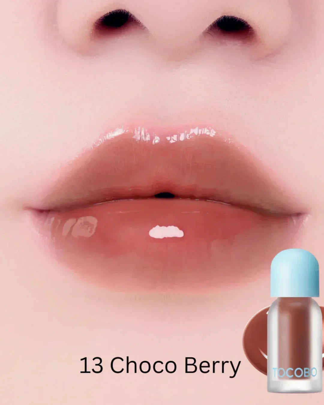 Close-up of glossy lips wearing TOCOBO Juicy Berry Plumping Lip Oil in shade 13 Choco Berry with product bottle