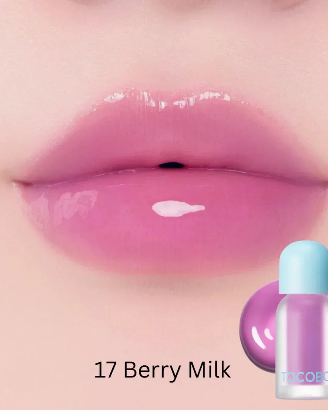 Close-up of lips wearing glossy pink lip oil shade 17 Berry Milk with product bottle