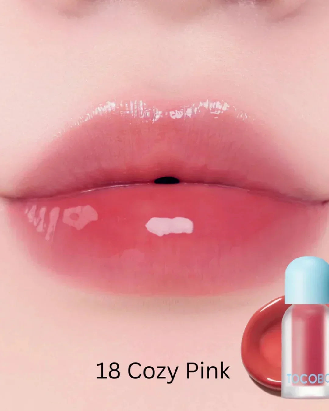 Close-up of glossy lips wearing Juicy Berry Plumping Lip Oil in shade 18 Cozy Pink with product bottle