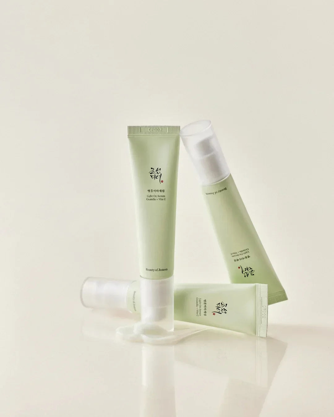 Beauty of Joseon Light On Serum Centella + Vita C 30ml tubes with cream spilled on light background