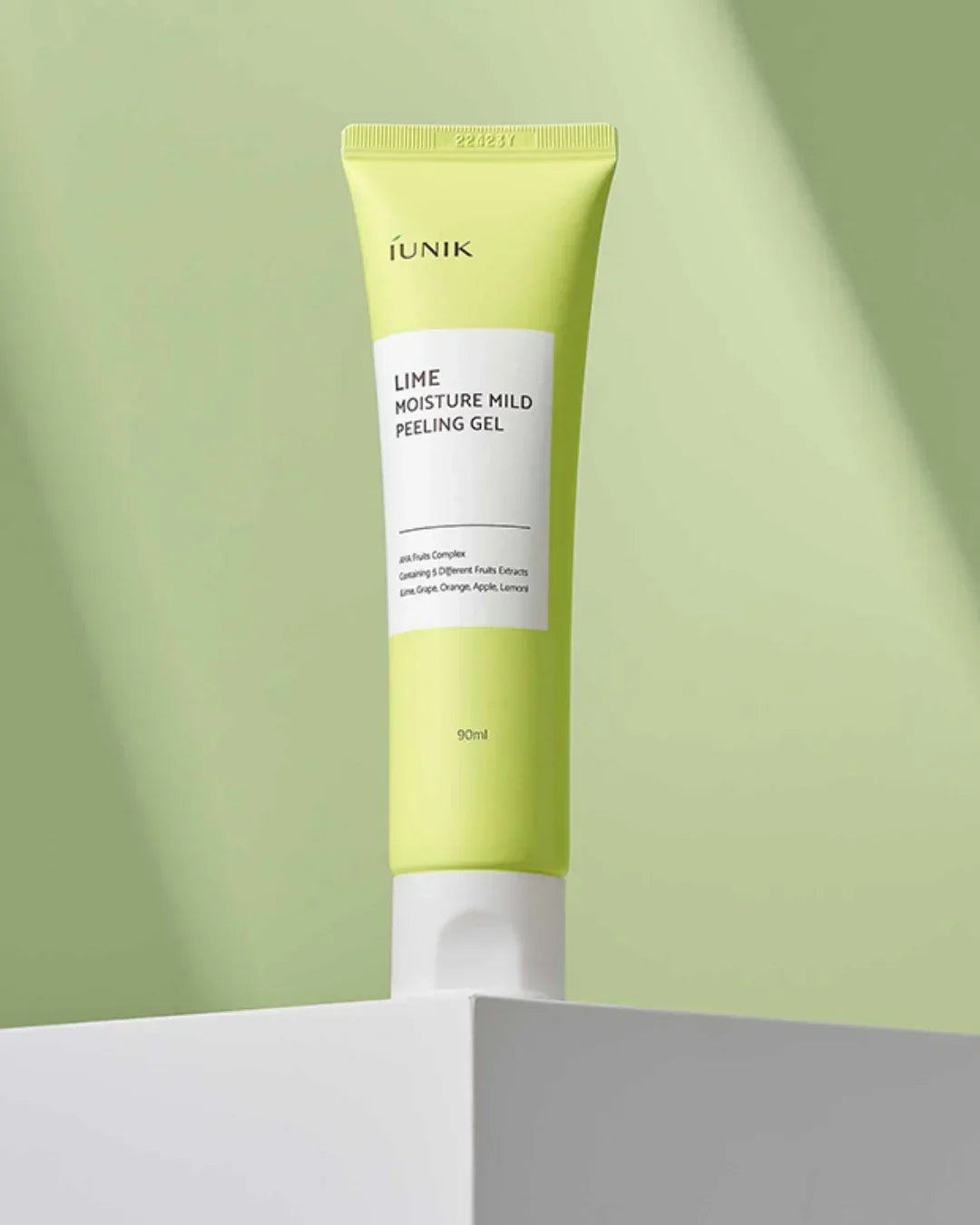 90ml iUNIK Lime Moisture Mild Peeling Gel tube on white pedestal with green background