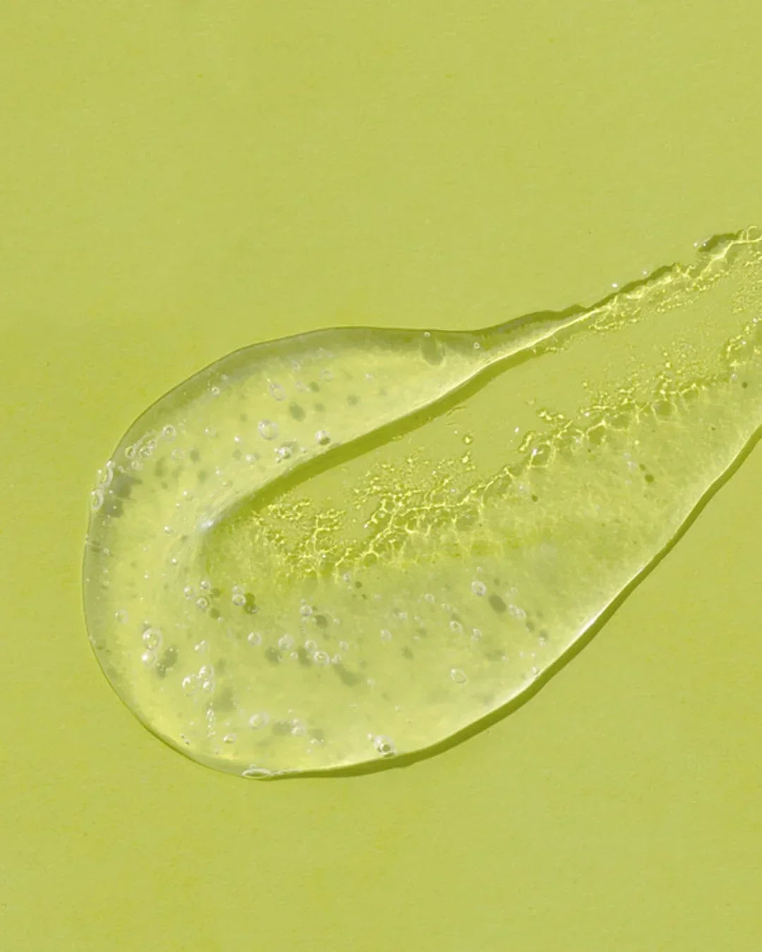Clear lime green gel with bubbles and texture on matching green background